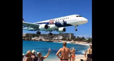 Mind your heads! Incredible footage of low flying plane