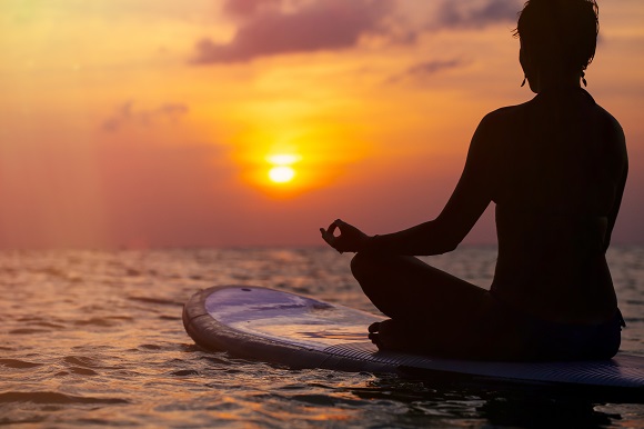 Paddleboard yoga at sunset